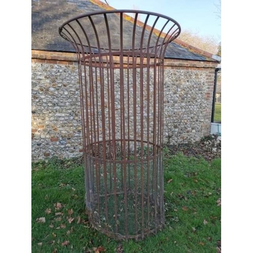 1538 - A large wrought iron tree guard, 217.5cm high x 128cm diameter.