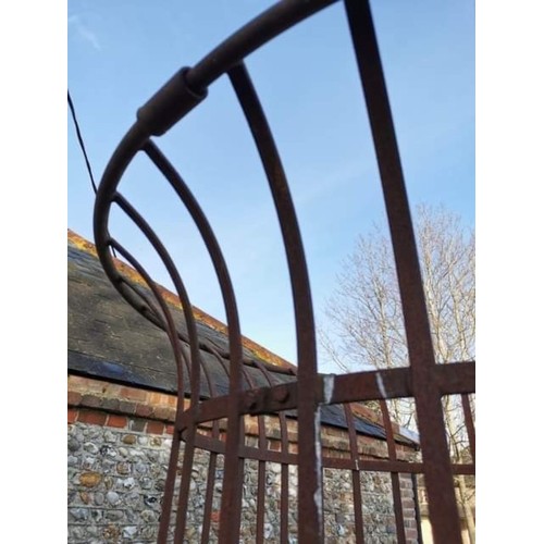 1538 - A large wrought iron tree guard, 217.5cm high x 128cm diameter.