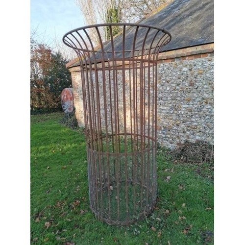 1538 - A large wrought iron tree guard, 217.5cm high x 128cm diameter.