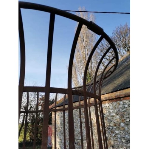 1538 - A large wrought iron tree guard, 217.5cm high x 128cm diameter.