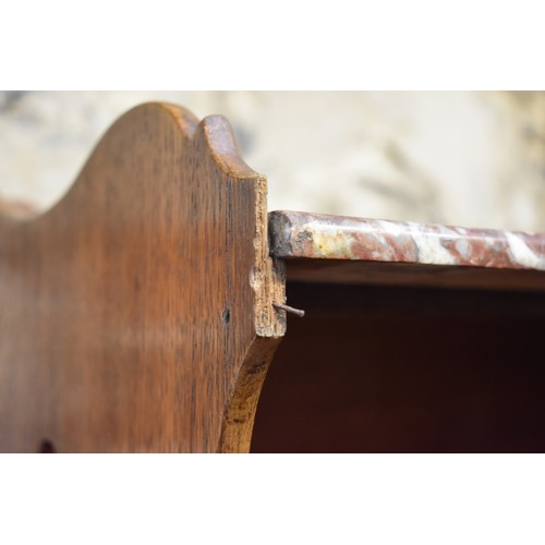 1184 - A pair of Continental oak and marble top bedside tables, 53.5cm wide.