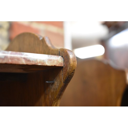 1184 - A pair of Continental oak and marble top bedside tables, 53.5cm wide.