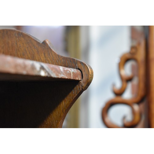 1184 - A pair of Continental oak and marble top bedside tables, 53.5cm wide.