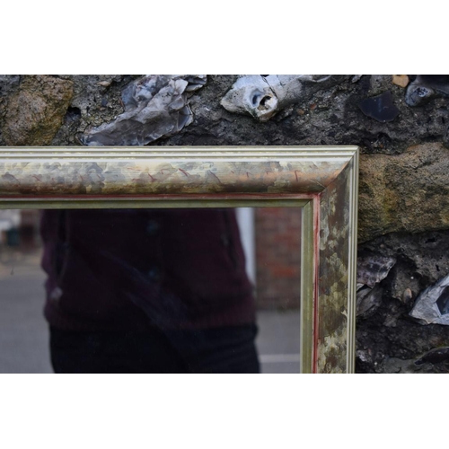 1058 - A gilt wall mirror, 110cm high x 84cm wide; together with another wall mirror, 112cm high x 85cm wid... 