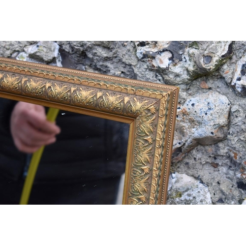 1058 - A gilt wall mirror, 110cm high x 84cm wide; together with another wall mirror, 112cm high x 85cm wid... 