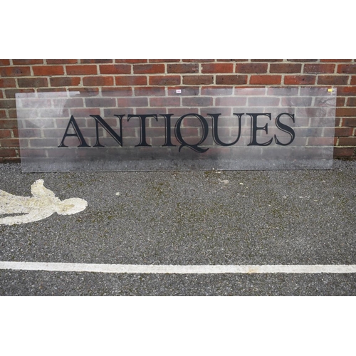 1063 - An acrylic 'Antiques' display sign, 221.5cm wide x 57cm high.Collection of this lot is strictly by a... 