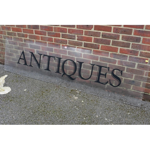 1063 - An acrylic 'Antiques' display sign, 221.5cm wide x 57cm high.Collection of this lot is strictly by a... 