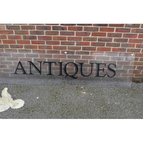 1063 - An acrylic 'Antiques' display sign, 221.5cm wide x 57cm high.Collection of this lot is strictly by a... 