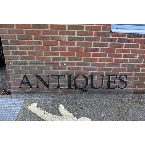 1064 - An acrylic 'Antiques' display sign, 188.5cm wide x 56cm high.Collection of this lot is strictly by a... 