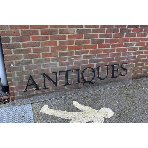 1064 - An acrylic 'Antiques' display sign, 188.5cm wide x 56cm high.Collection of this lot is strictly by a... 