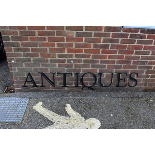 1064 - An acrylic 'Antiques' display sign, 188.5cm wide x 56cm high.Collection of this lot is strictly by a... 