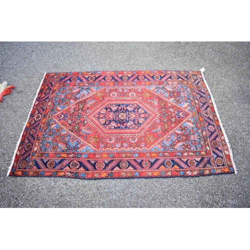 1089a - A Persian rug, having central diamond medallion with floral borders, 158 x 110cm.