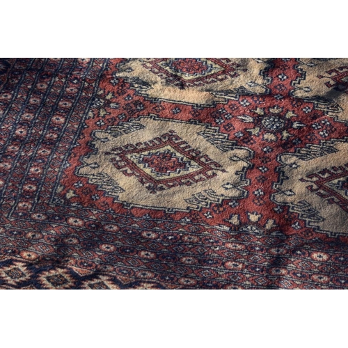 1090 - A Bokhara carpet, having repeated design to central field with geometric borders, 366 x 307cm.... 