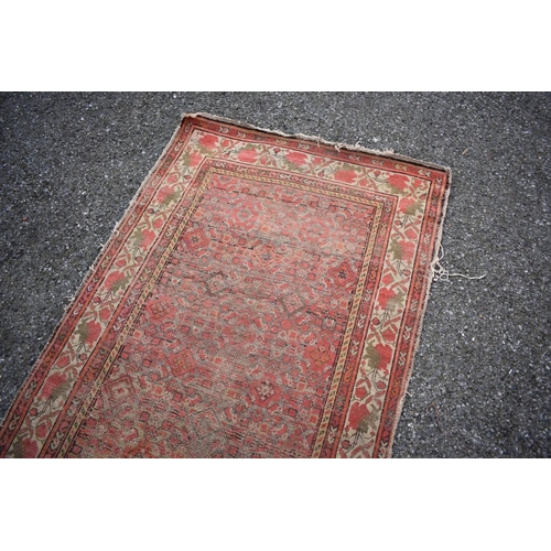 1090a - A Persian runner, having geometric decoration to central field with floral borders, 405 x 100cm.... 