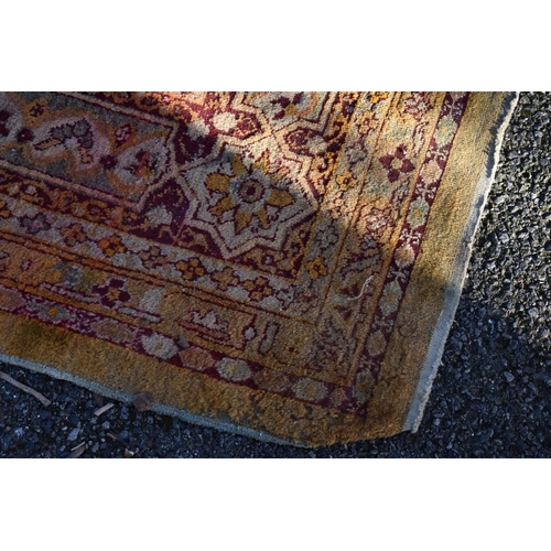 1092 - A Persian rug, having floral cartouches to central field with floral borders, 288 x 224cm.... 