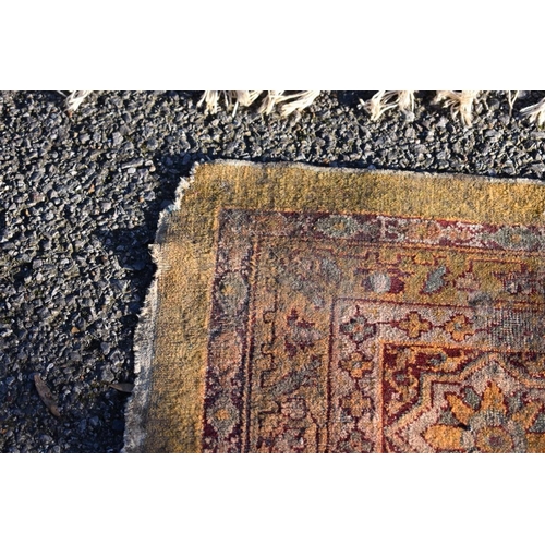 1092 - A Persian rug, having floral cartouches to central field with floral borders, 288 x 224cm.... 