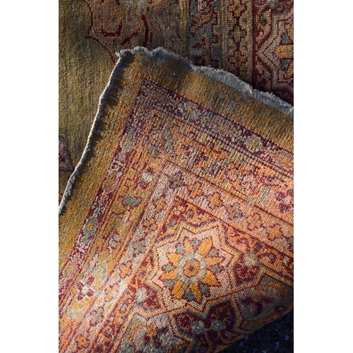 1092 - A Persian rug, having floral cartouches to central field with floral borders, 288 x 224cm.... 