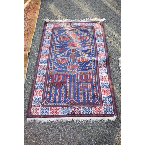 1094 - A Persian rug, having temple and urn design to central field, on a red and blue ground, 128 x 85cm.... 