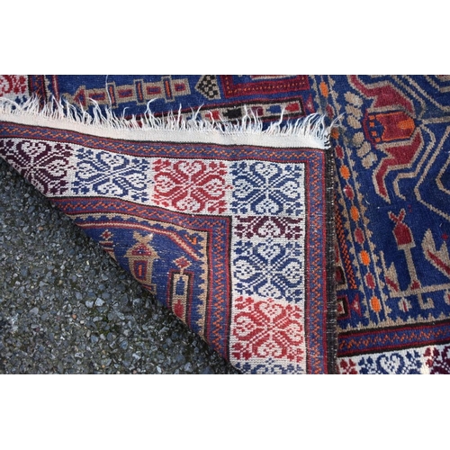 1094 - A Persian rug, having temple and urn design to central field, on a red and blue ground, 128 x 85cm.... 