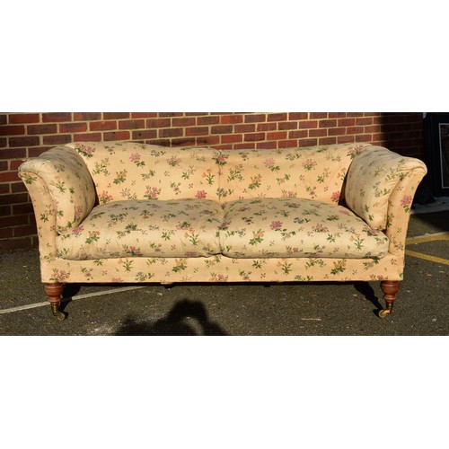 1433 - A Howard &amp; Sons 'Baring' settee, on turned walnut legs to the front, all castors stamped, labell...