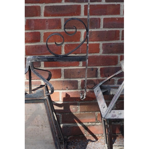 1075 - Two similar copper street lamps, one with wrought iron wall bracket, 83cm high x 60cm wide. 