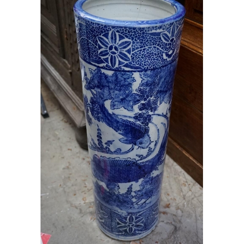 1083 - A Japanese blue and white stickstand, 61cm high, (cracked to rim). 