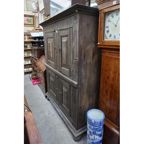 1085 - A carved oak panelled press cupboard, probably late 17th century, 150cm wide. 