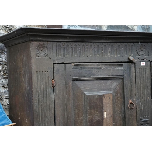 1085 - A carved oak panelled press cupboard, probably late 17th century, 150cm wide. 