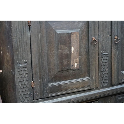 1085 - A carved oak panelled press cupboard, probably late 17th century, 150cm wide. 