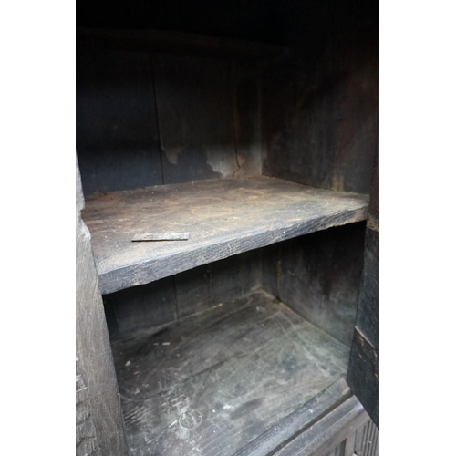 1085 - A carved oak panelled press cupboard, probably late 17th century, 150cm wide. 