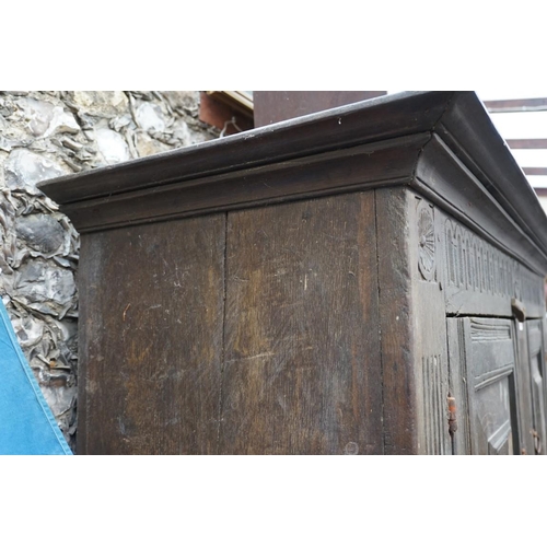 1085 - A carved oak panelled press cupboard, probably late 17th century, 150cm wide. 