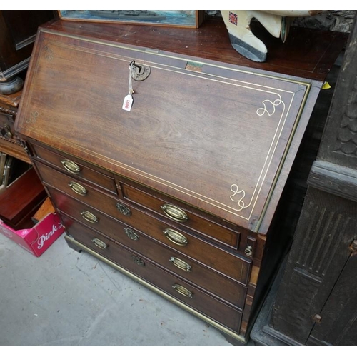 1086 - An unusual George III mahogany and brass inlaid bureau, in the manner of John Channon, the fall encl... 