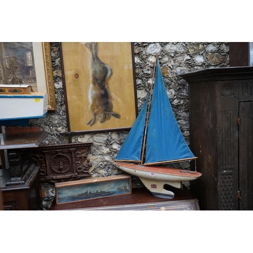 1087 - An old pond yacht, the hull 62.5cm; together with another diorama of a battleship, 49.5cm wide. (2)... 