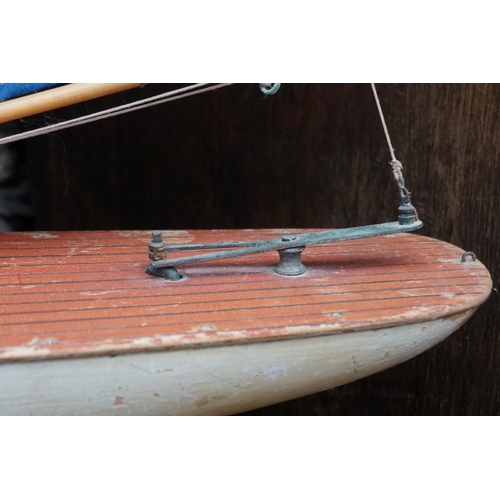 1087 - An old pond yacht, the hull 62.5cm; together with another diorama of a battleship, 49.5cm wide. (2)... 