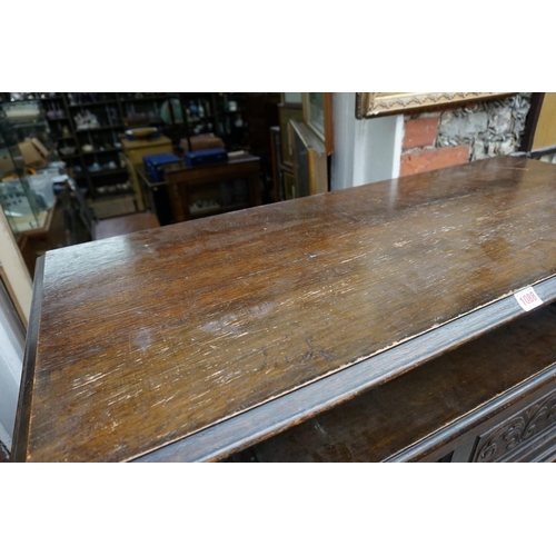 1088 - A carved oak monks bench, with hinged box seat, 106.5cm wide.