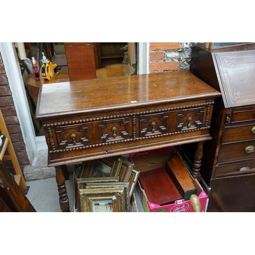 1089 - A reproduction oak geometrically moulded two drawer side table, 106cm wide. ... 