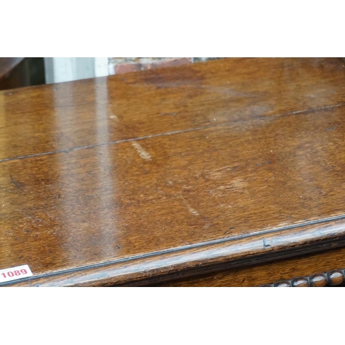 1089 - A reproduction oak geometrically moulded two drawer side table, 106cm wide. ... 