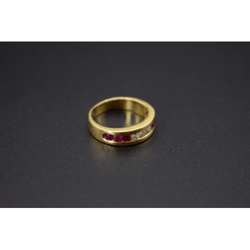 74 - A yellow metal diamond and ruby half eternity ring, stamped .750, size I 1/2.