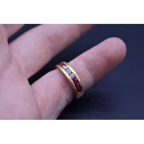 74 - A yellow metal diamond and ruby half eternity ring, stamped .750, size I 1/2.