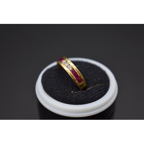 74 - A yellow metal diamond and ruby half eternity ring, stamped .750, size I 1/2.