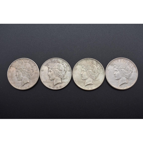 155 - Coins: four US silver peace dollars, 1922 (2) and 1923 (2).