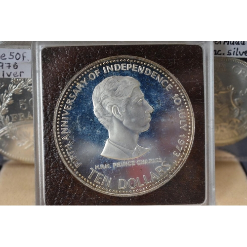 162 - Coins: a Commonwealth of the Bahamas 1978 silver $10 commemorative coin; together with a French 1976... 