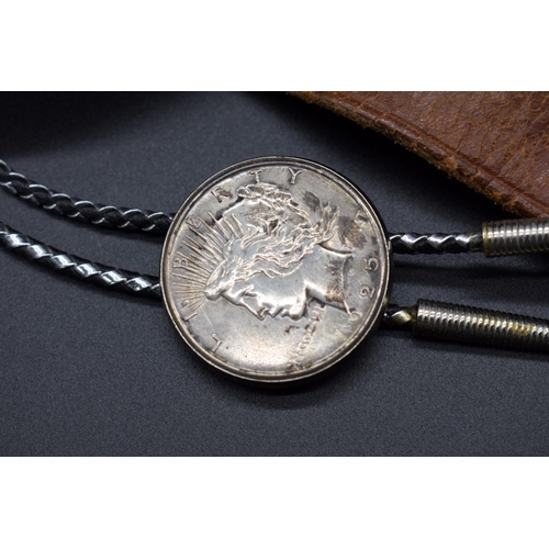 167 - Coins: a US 1925 silver dollar, mounted into lariat type necklace; together with a 1922 silver dolla... 