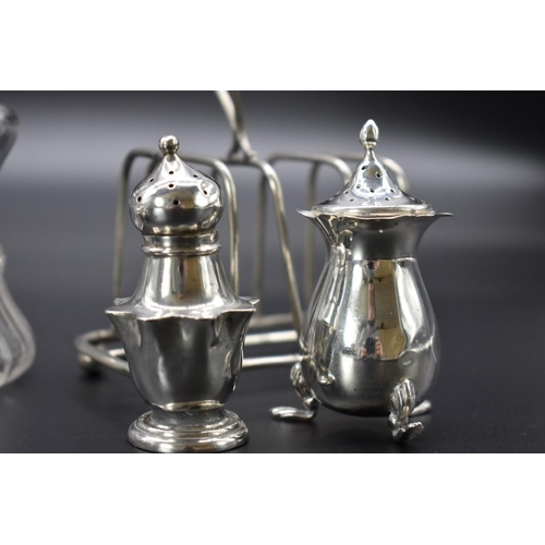 63 - A quantity of silver, to include: a five piece cruet set; and a silver lidded glass preserve jar.... 