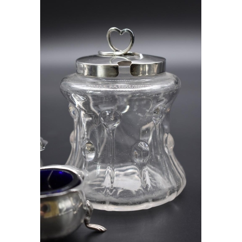 63 - A quantity of silver, to include: a five piece cruet set; and a silver lidded glass preserve jar.... 