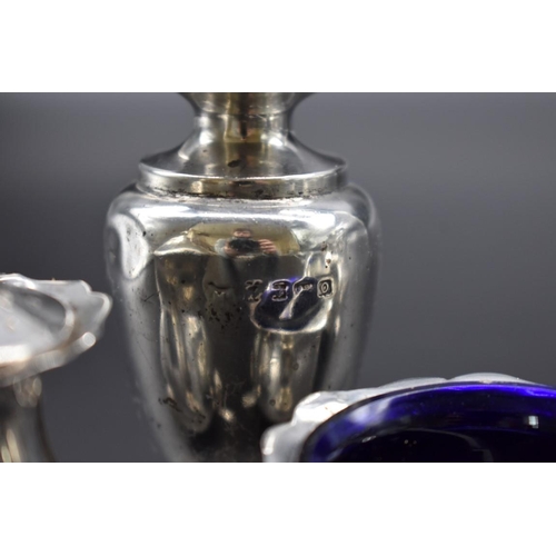 63 - A quantity of silver, to include: a five piece cruet set; and a silver lidded glass preserve jar.... 