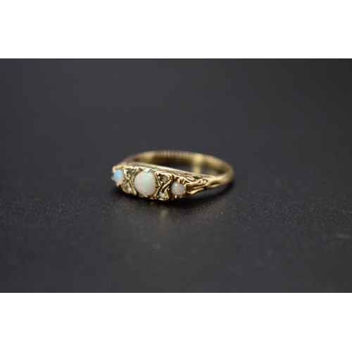 71 - A 9ct gold ring set three opals and four small diamonds, total weight 2.6g, size M1/2.... 