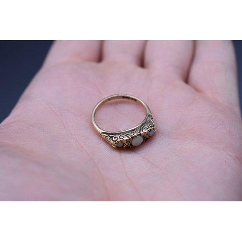 71 - A 9ct gold ring set three opals and four small diamonds, total weight 2.6g, size M1/2.... 