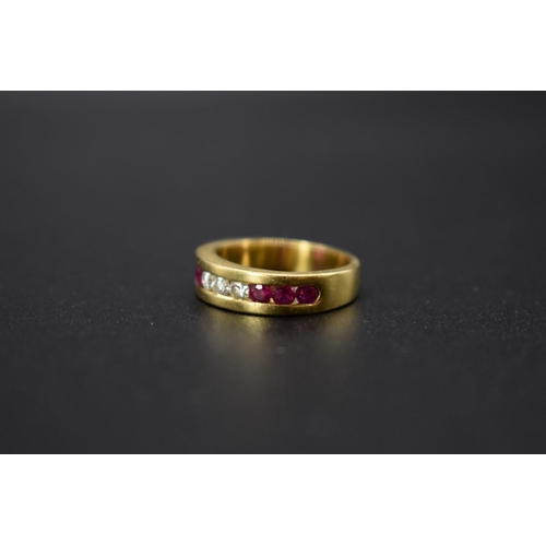 74 - A yellow metal diamond and ruby half eternity ring, stamped .750, size I 1/2.