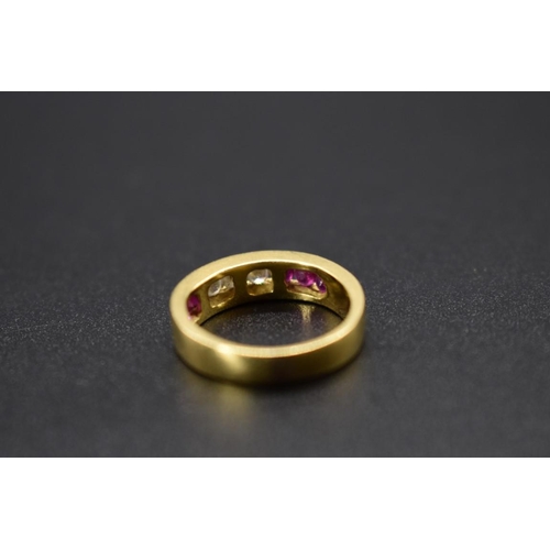 74 - A yellow metal diamond and ruby half eternity ring, stamped .750, size I 1/2.